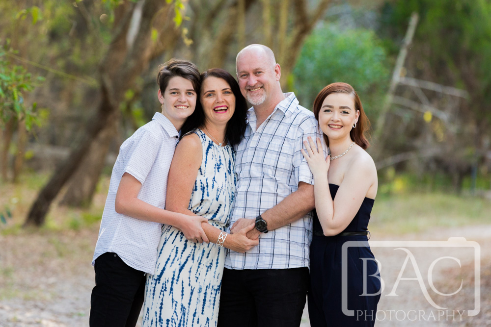 Outdoor family portrait with family of 4. 2 adults and 2 teenage children