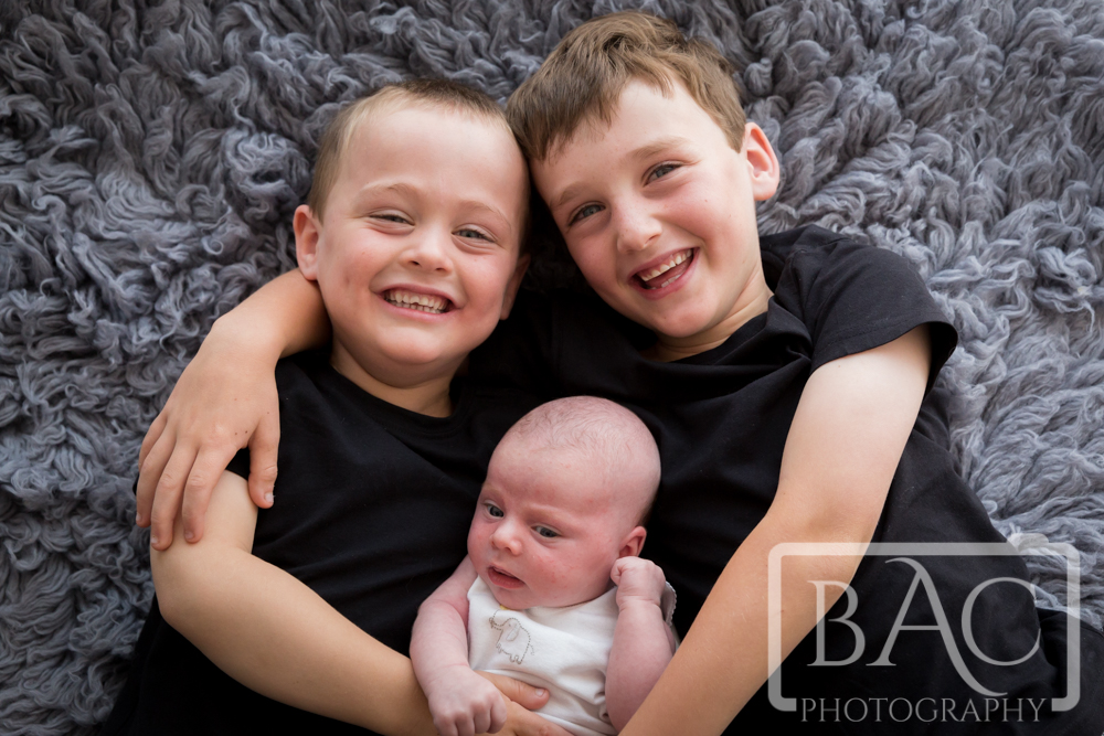 Big brothers with newborn sister