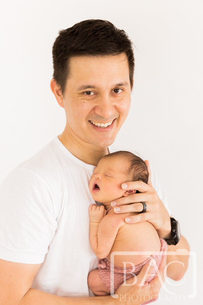 Proud Dad portrait with newborn baby girl