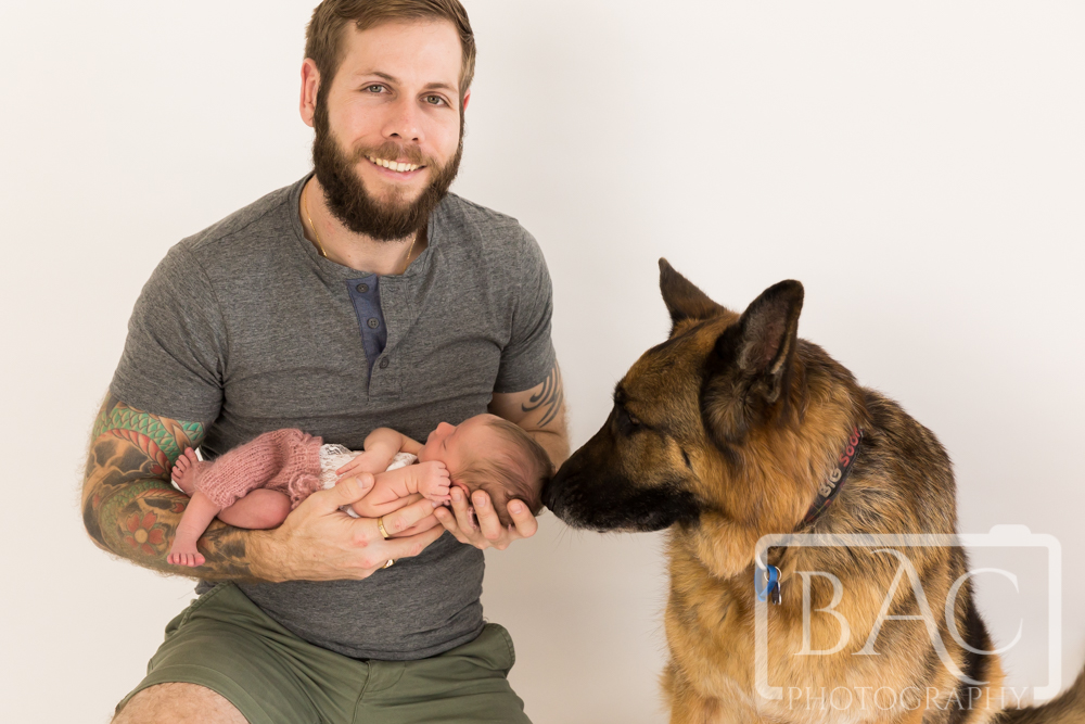 Portrait of Dad with newborn baby and German Shepherd