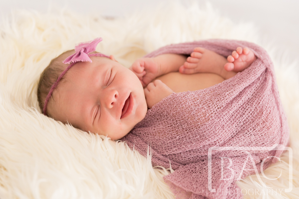 Newborn baby girl smiling