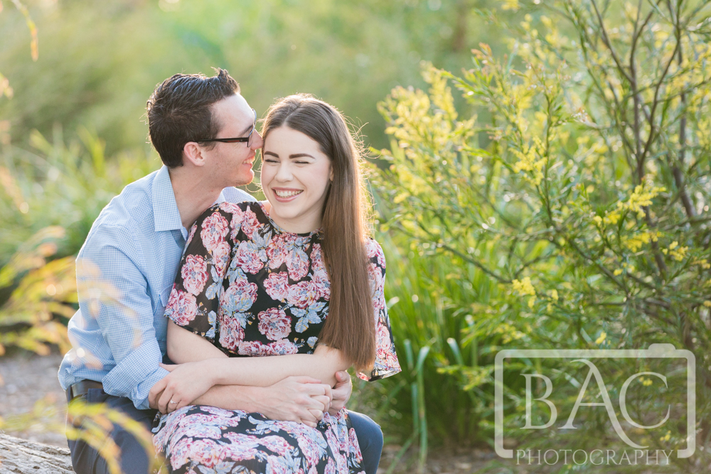 Couples outdoor portrait whispering sweet nothings