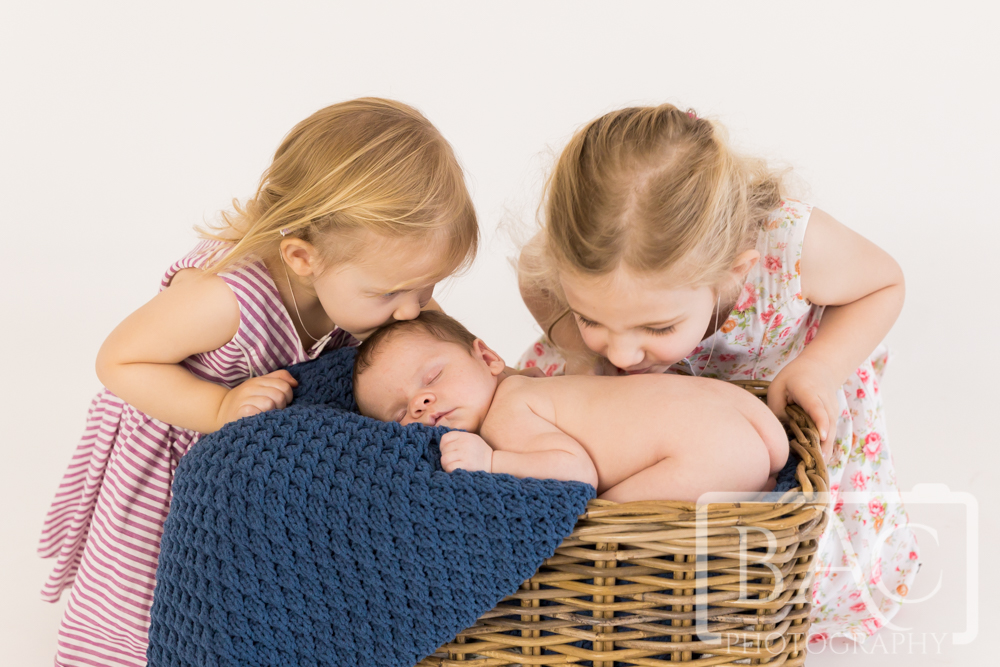 Newborn baby boy with his two siblings