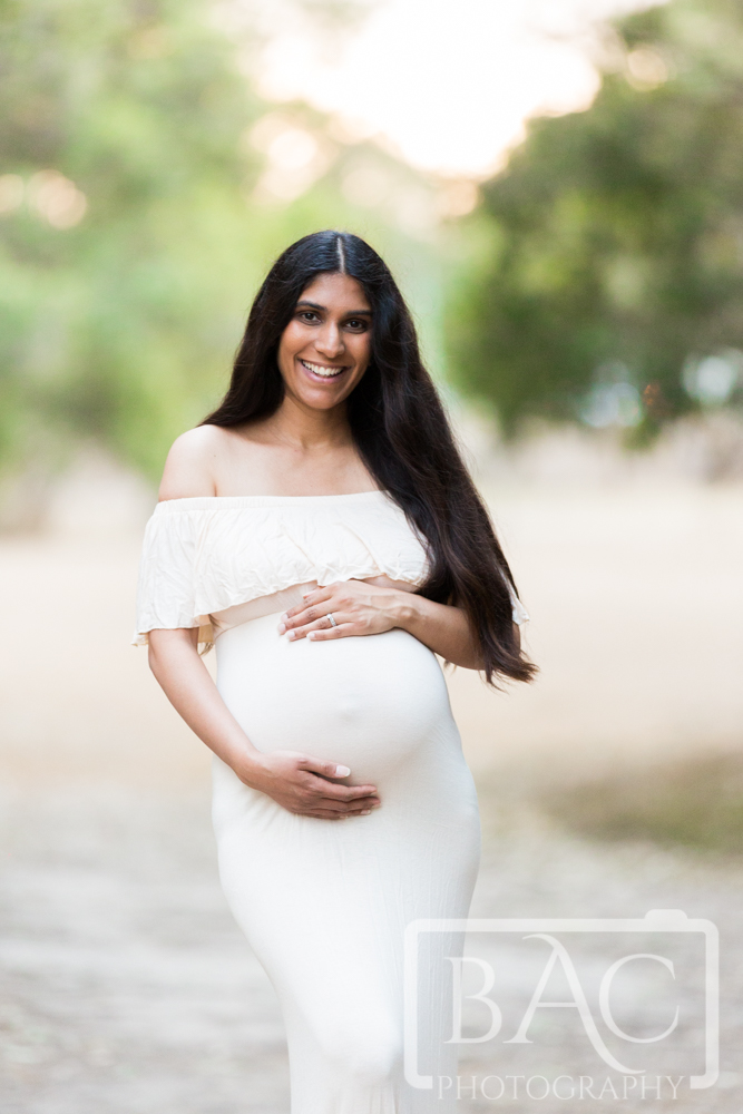 maternity portrait top half with cream dress outdoors