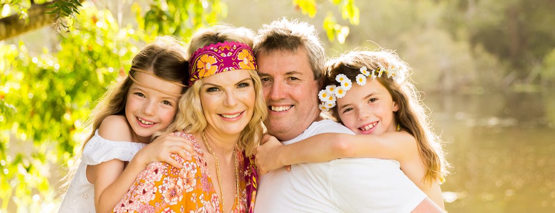 colourful hippie style outdoor family portait parents and two girls