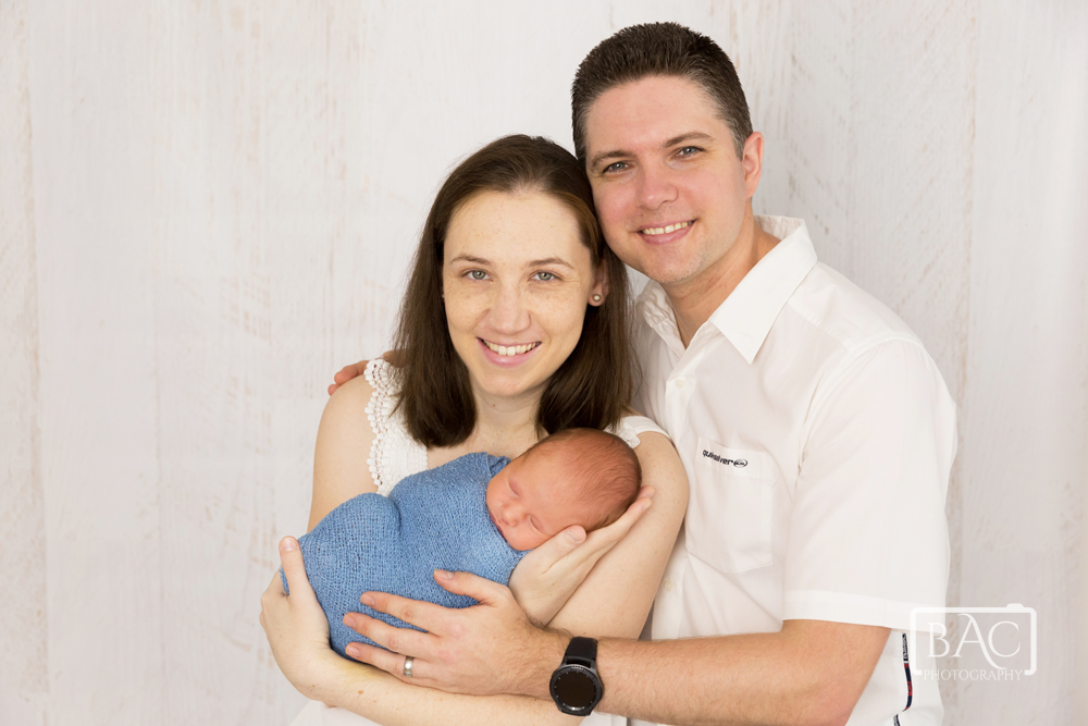 Newborn portrait of parents with son