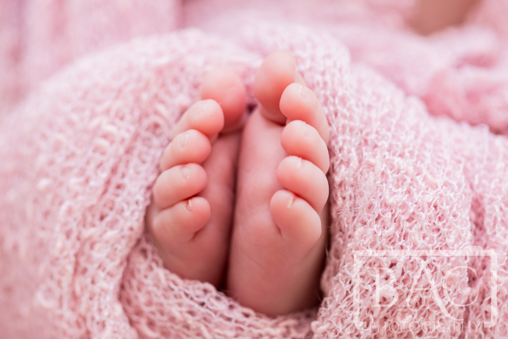 Close up of Newborn girls toes portrait wrapped in pink