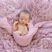 16 Day old Newborn girl portrait wrapped in pink