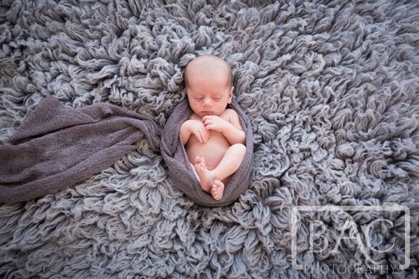 Newborn Baby boy on grey rug