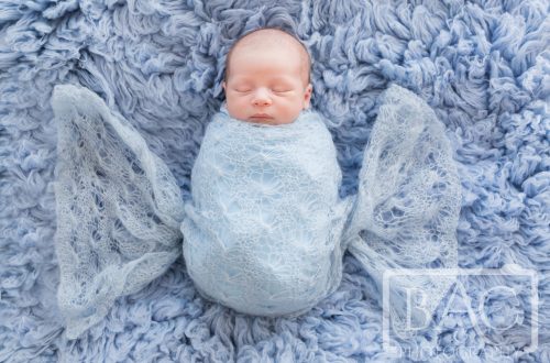 Newborn baby boy wrapped in blue