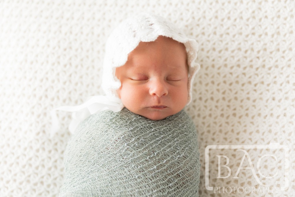 newborn in knit bonnet