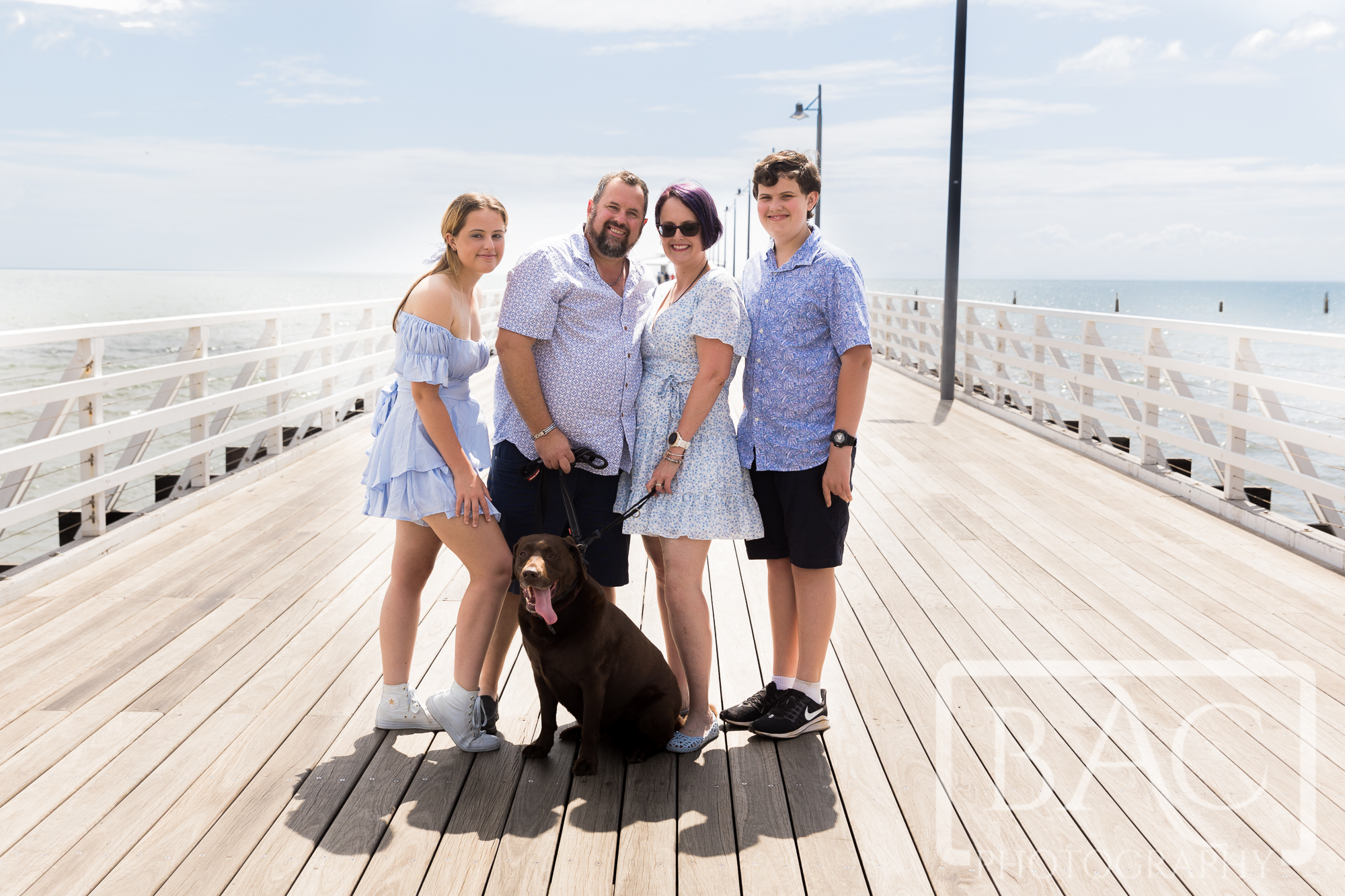 family portrait with dog on jetty