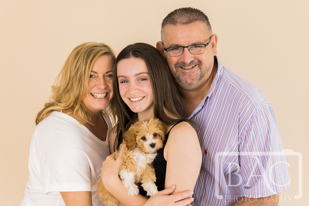family portrait in studio with new puppy