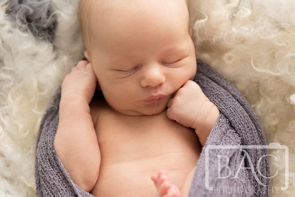 gorgeous newborn pouting studio portrait
