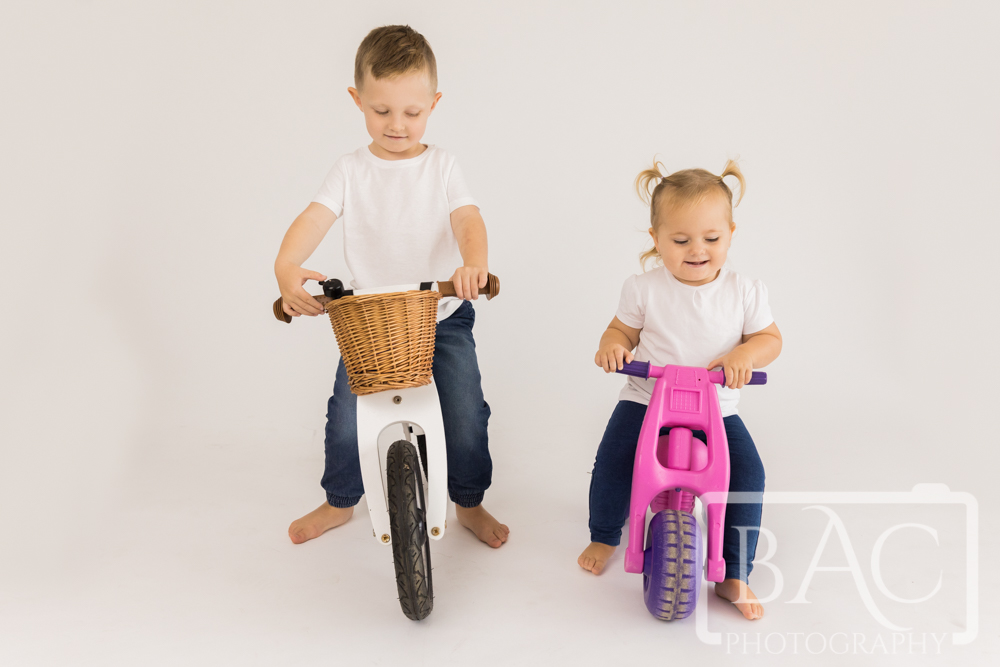 kids riding bikes fun studio portrait