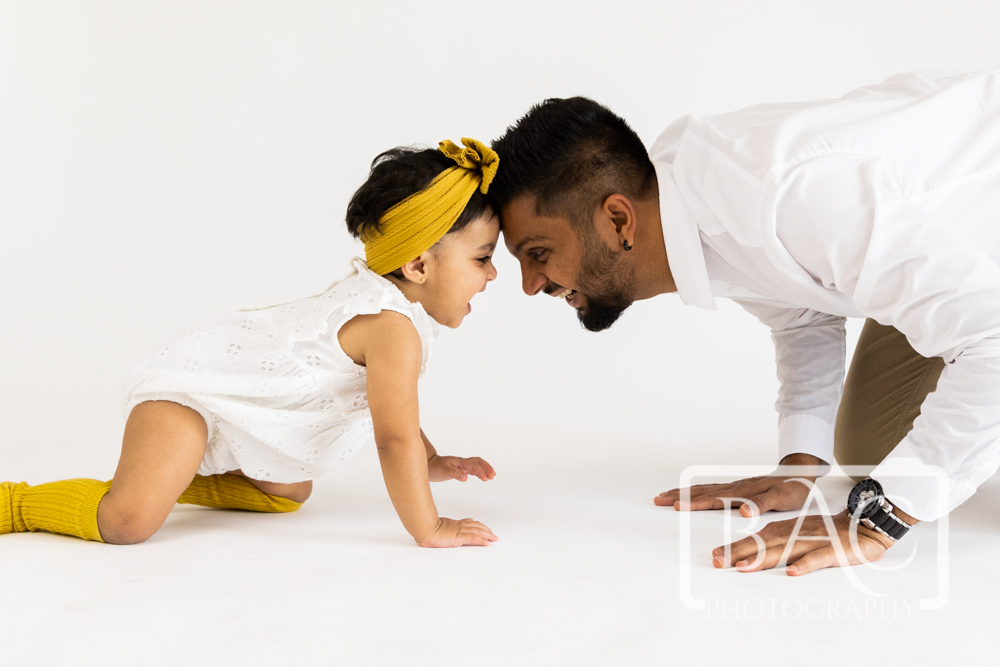dad and daughter fun studio portrait head butts